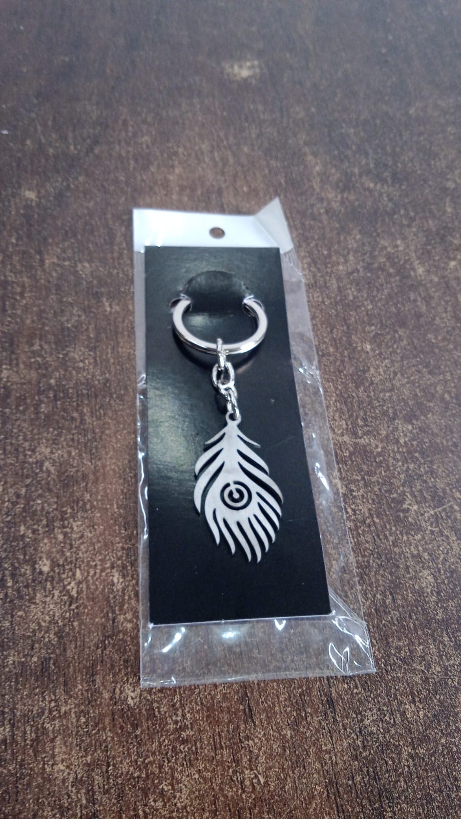 Stainless steel keychain with intricate peacock feather motif