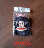 A mini hot water bag with a vibrant emoji cover in active use.