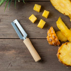Stainless steel peeler with ergonomic wooden handle designed for comfort