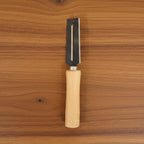Sharp stainless steel blade of multipurpose vegetable peeler clearly visible