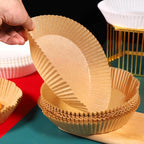 Multiple disposable air fryer paper sheets demonstrating their bowl shape and high edges.