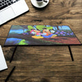 A vibrant cartoon-printed kids study table with foldable legs, perfect for learning and play.