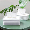 Modern silicone tissue holder with wave design on an office desk.