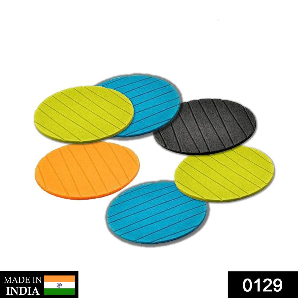 Six plain round silicone drink coasters neatly stacked, ready for use.