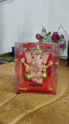 Close-up shot of the solar panel and detailed Lord Ganesha idol