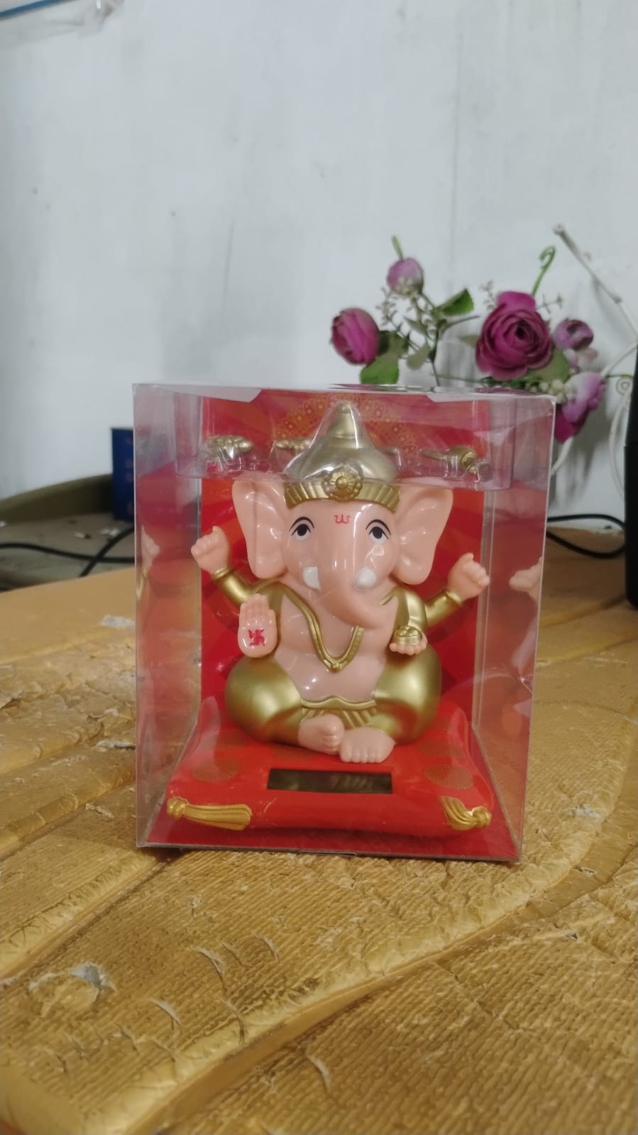 Close-up shot of the solar panel and detailed Lord Ganesha idol
