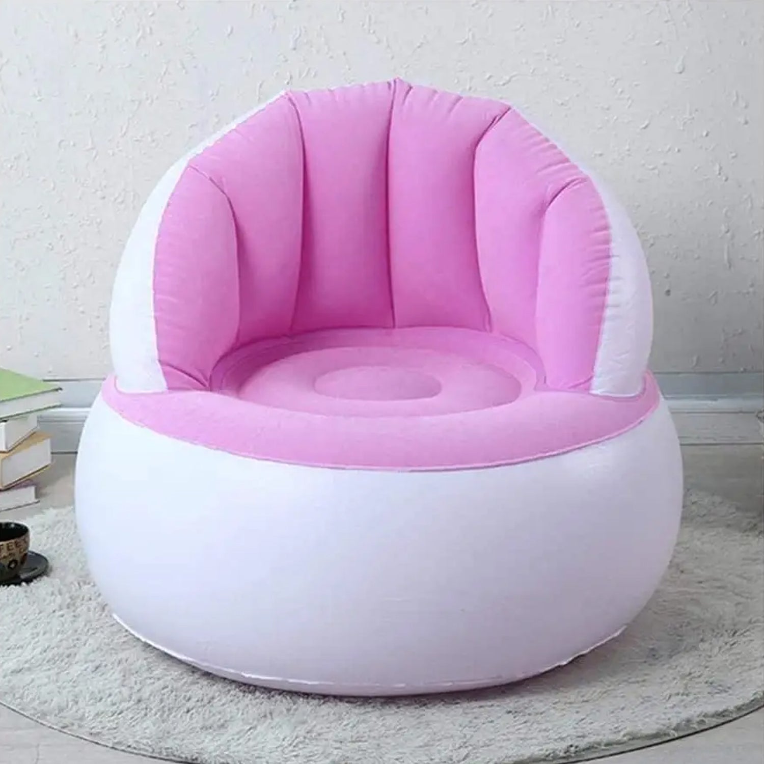 Child happily sitting on a bright yellow Kids Inflatable Sofa Chair with backrest.