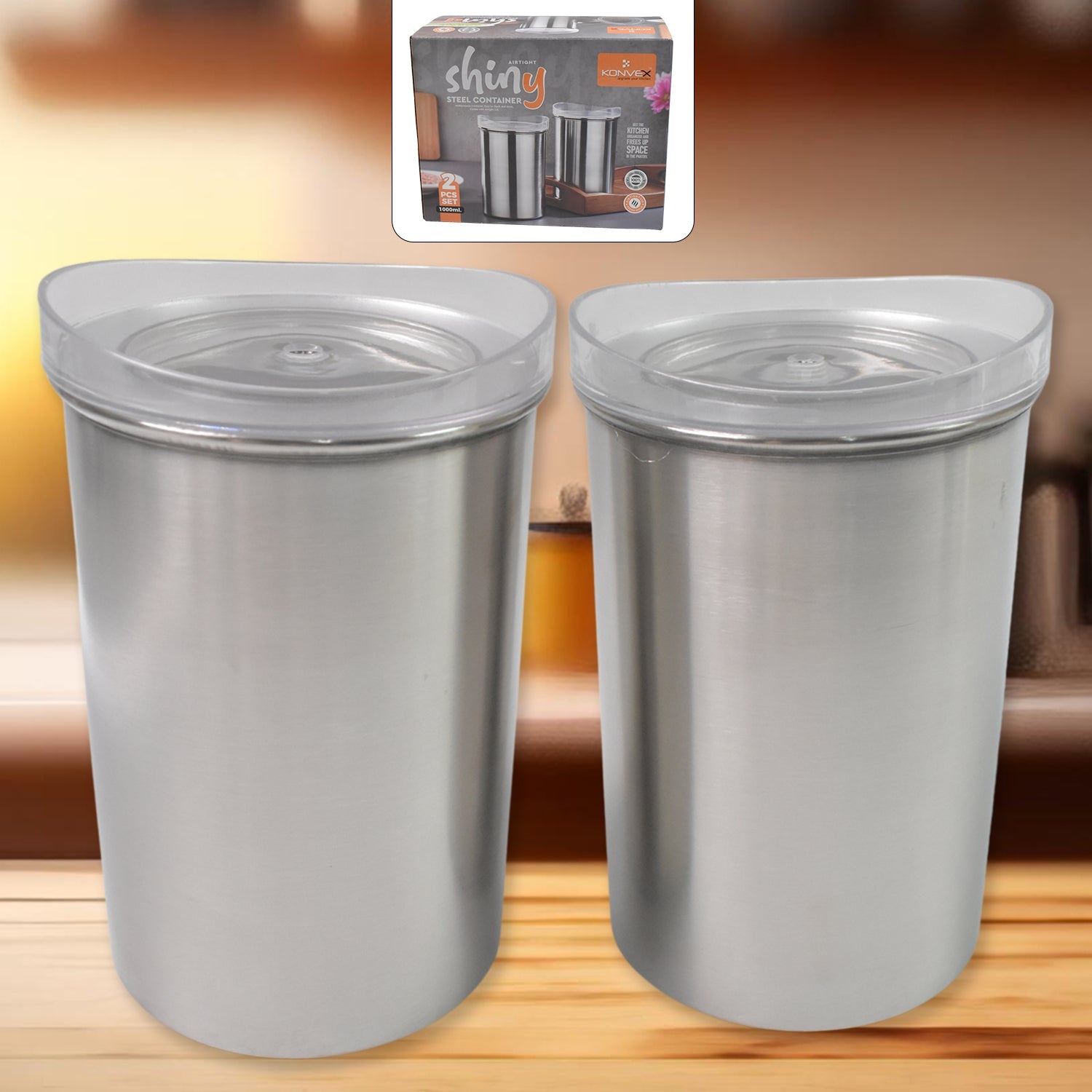 Two stainless steel airtight containers with transparent lids, filled with spices on a wooden surface.