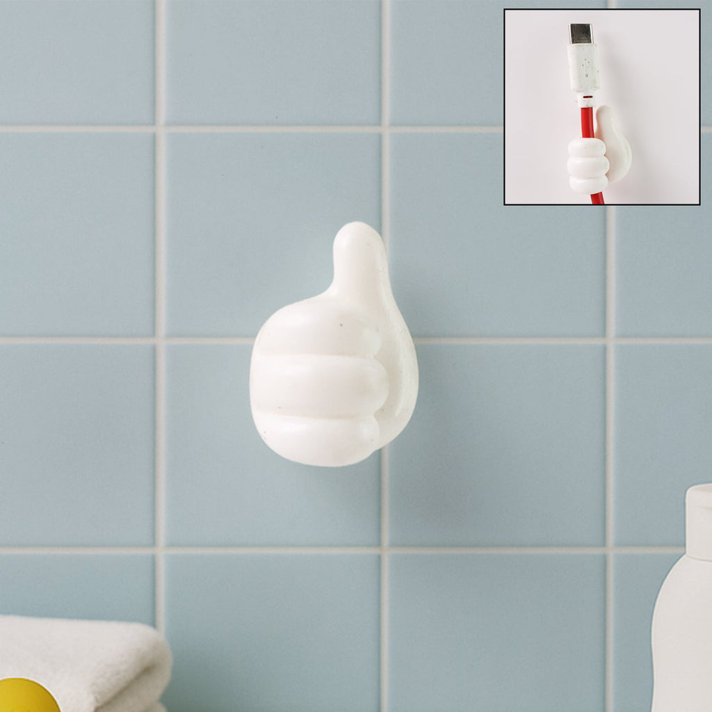 White hand-shaped wall clip holding keys and cables with thumb grip