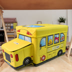 School Bus Toy Storage Box by Dollamis, partially open, showcasing its vibrant design.