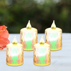 A set of four flickering flameless LED candles arranged on a surface, ideal for home decor.