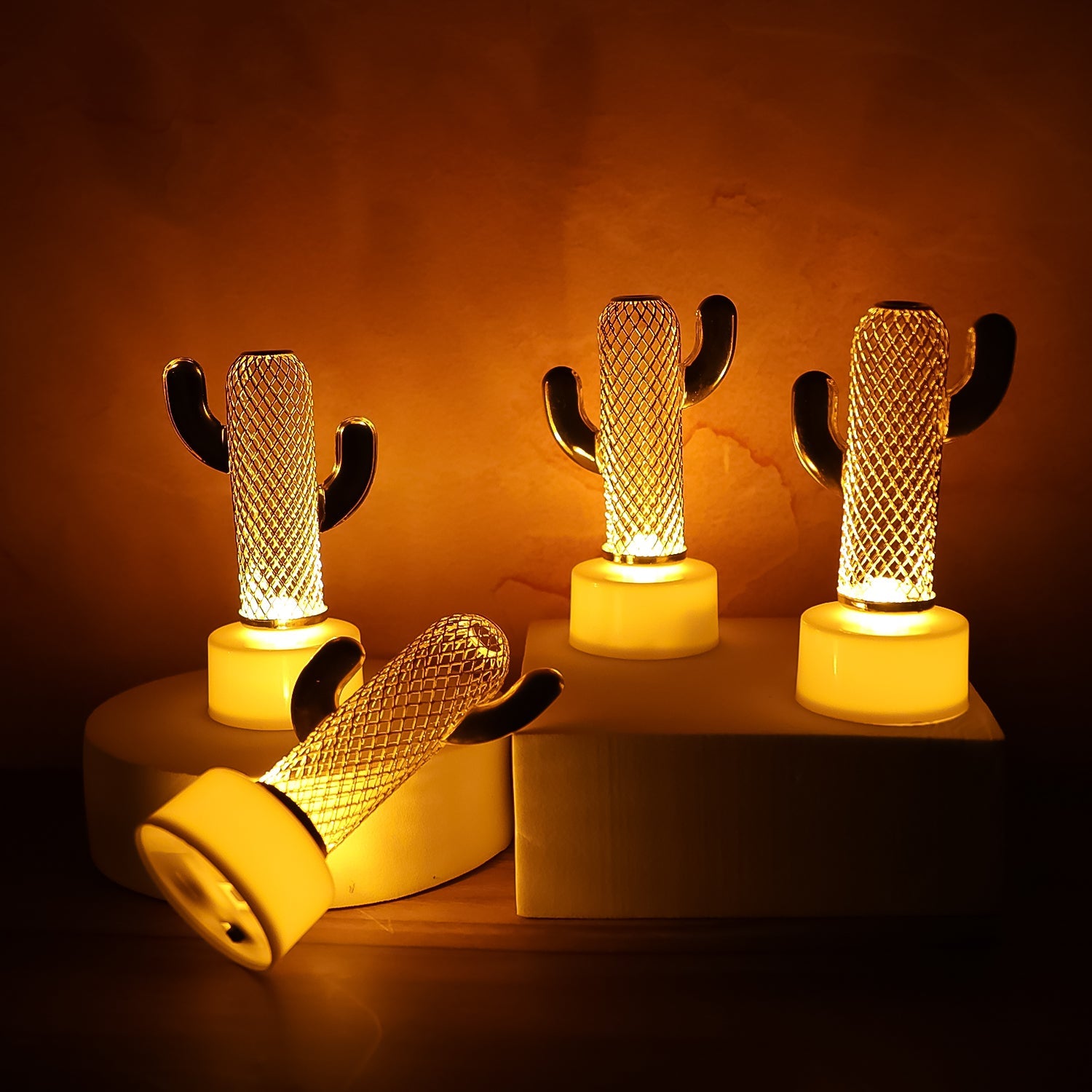 Set of four Cactus Shaped Flameless LED Candles displaying a warm, flickering glow against a dark background.