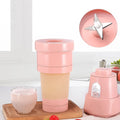 Compact Portable Electric Juicer with lid on a clean surface.
