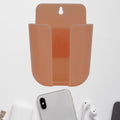 Wall mounted phone holder with a charging port in a modern living space.