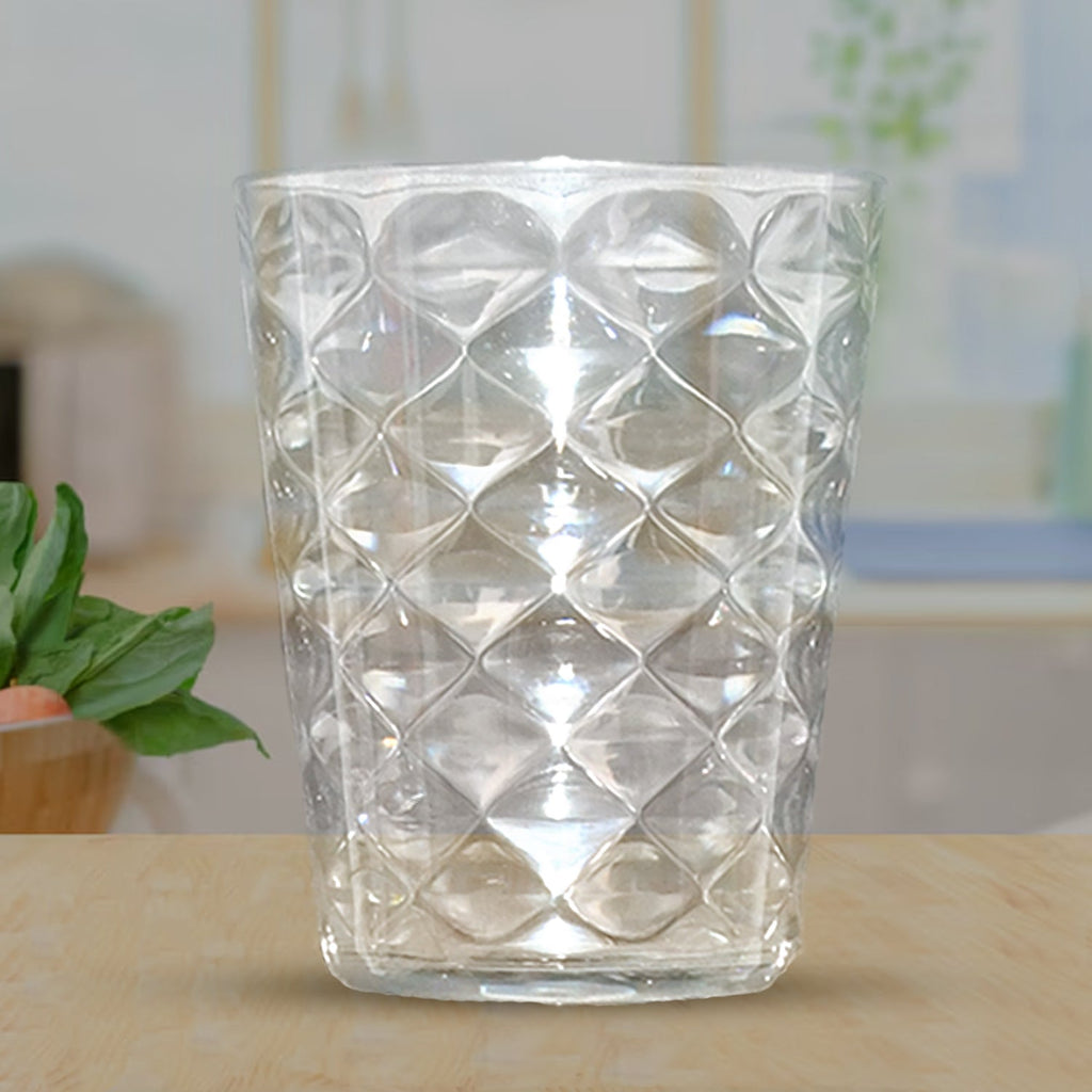 Crystal clear pyramid glass tumbler filled with cold beverage