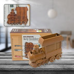 Brown plastic train key holder mounted on a white wall.