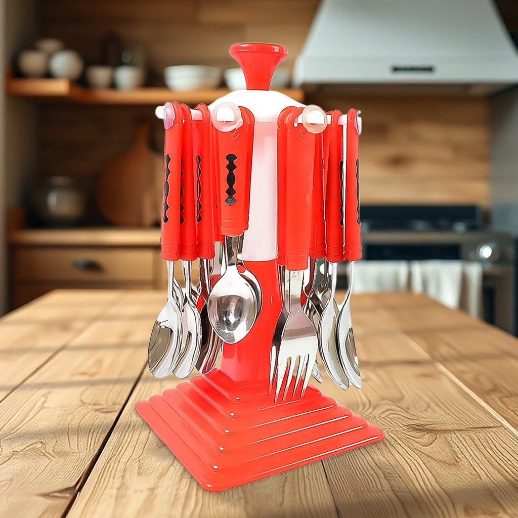 Stainless steel cutlery set with a revolving stand on a dining table.