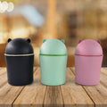 Mini tabletop dustbin in mixed color showing compact swing lid design