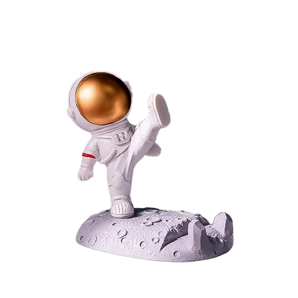 Another angle of the spaceman phone stand holding a mobile device on a desk.