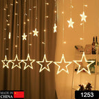 Close-up of decorative star-shaped LED bulbs on a window curtain light string.