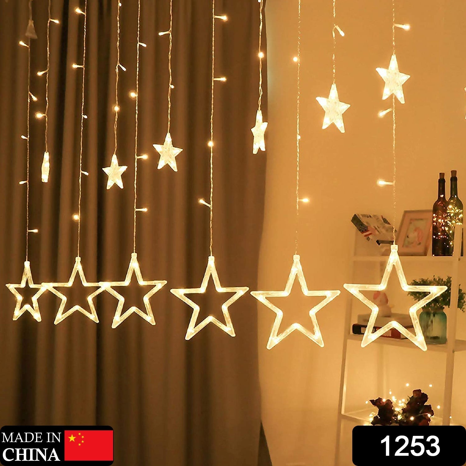 Close-up of decorative star-shaped LED bulbs on a window curtain light string.