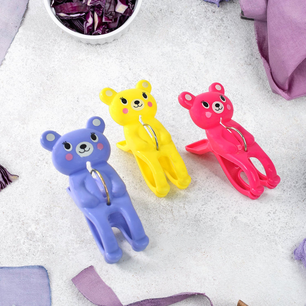 Windproof plastic towel clips holding wet clothes on a line
