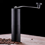 Siplix portable stainless steel manual coffee grinder standing upright.