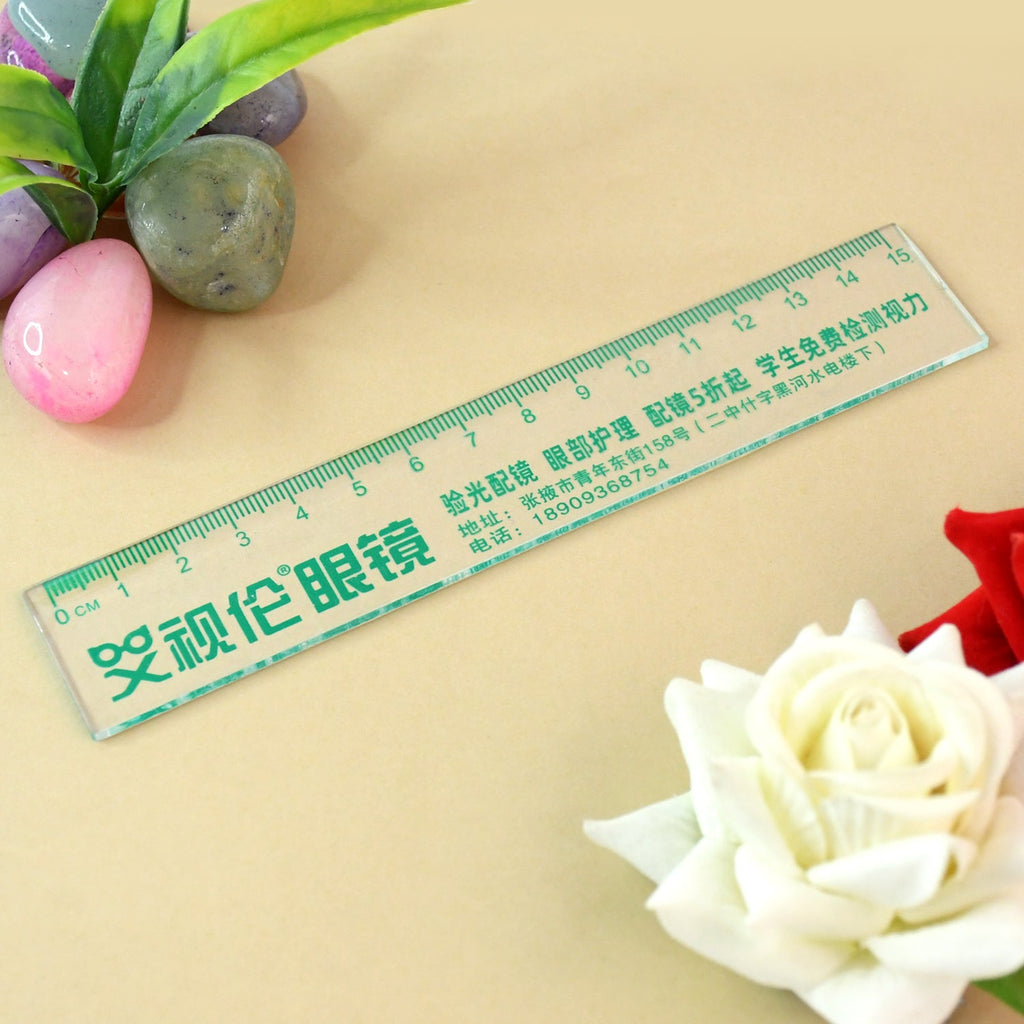 Closeup of green Chinese text on transparent plastic 15cm scale