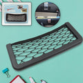 Car seat organizer mesh attached to the side of a car seat, holding a phone.