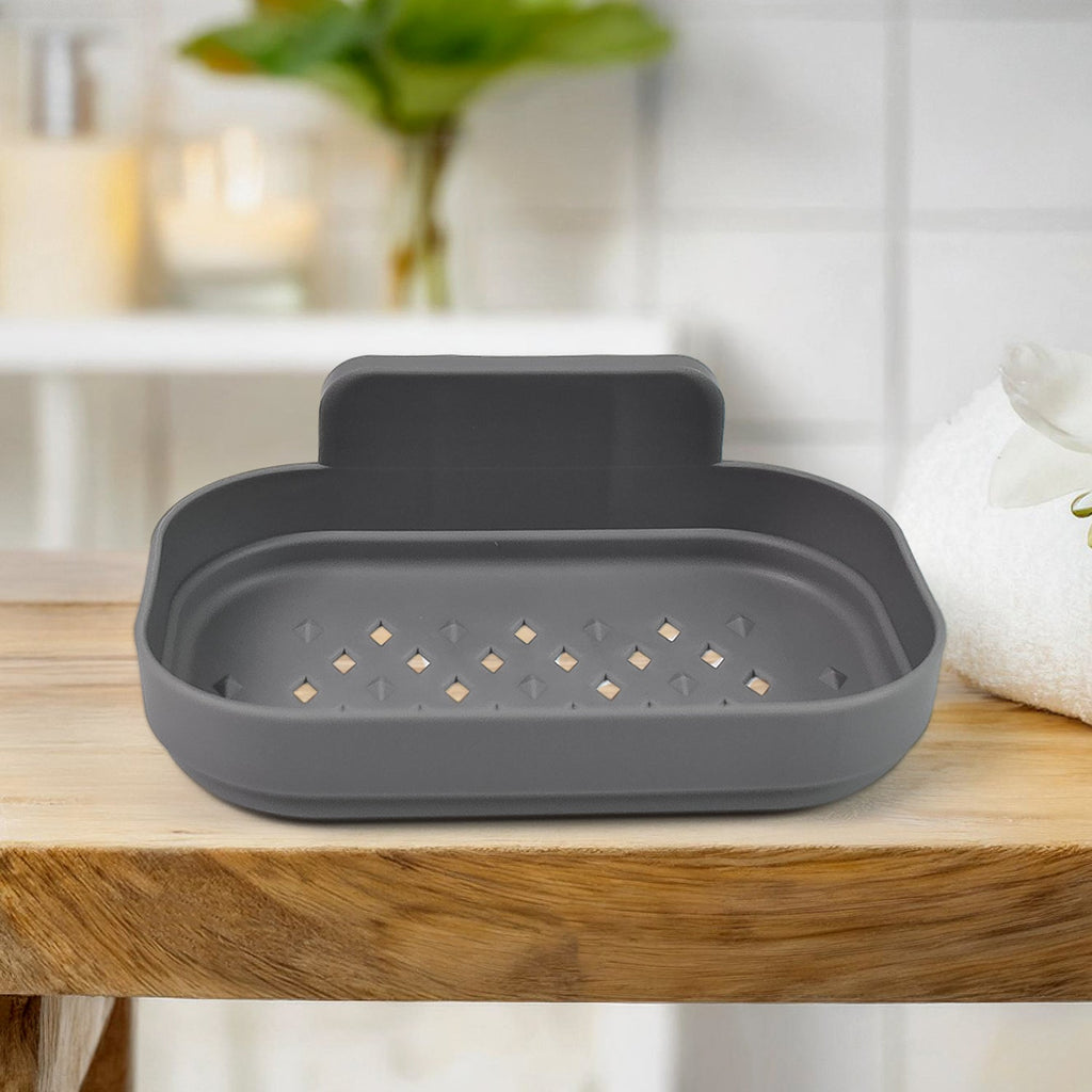 Close-up view of the transparent plastic soap dish holder showcasing its strong adhesive backing.