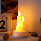 A pair of realistic LED taper candles flickering with warm white light, perfect for home decor.