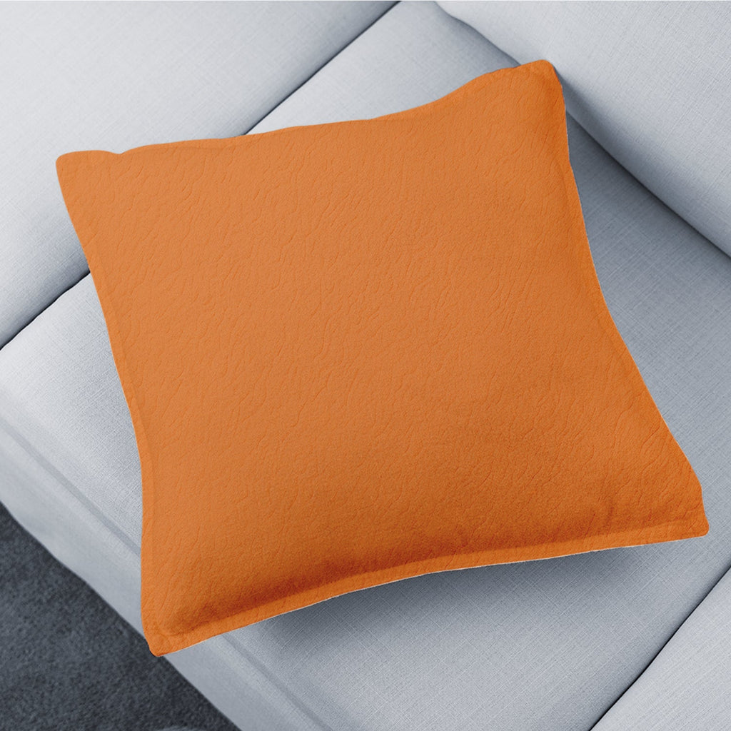 A stylish brown decorative pillow cover on a sofa, adding warmth to the living room.
