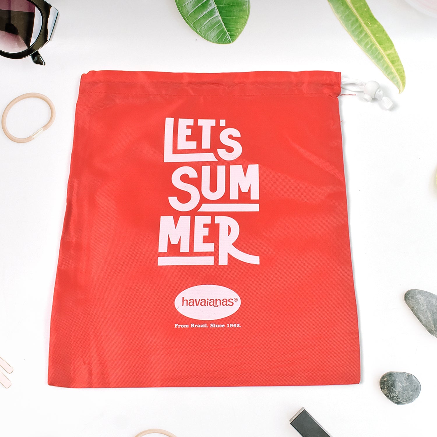 Multipurpose drawstring bag in red on a clean white background.