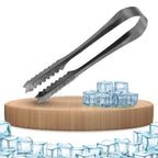 Stainless steel tongs gripping ice cubes on a white background.