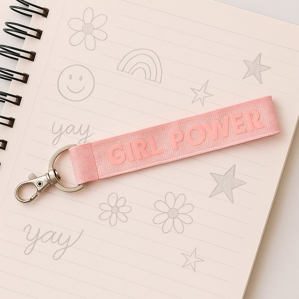 Girl Power fabric ribbon keychain with vibrant pink embossed strap on metal ring