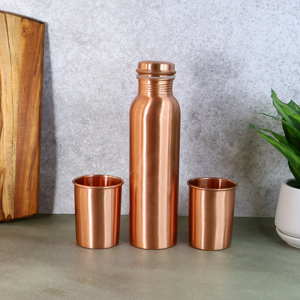 Elegant Copper Water Bottle Set with two matching glasses, presented in a gift box.