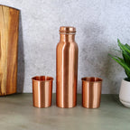 Elegant Copper Water Bottle Set with two matching glasses, presented in a gift box.