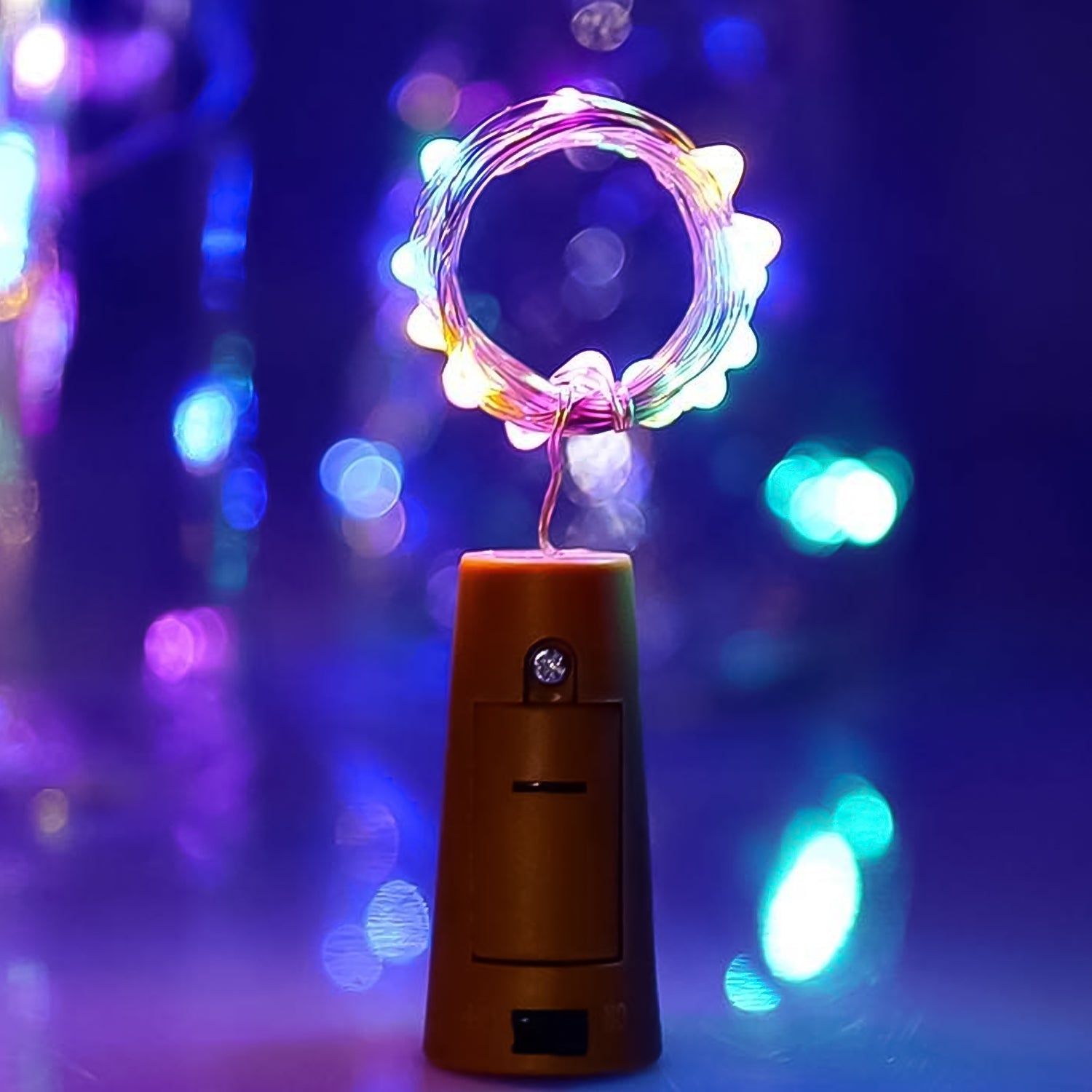 A multi-color LED bottle cork light illuminating an empty wine bottle, creating a festive glow.