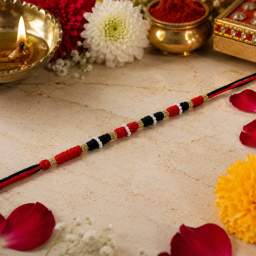Traditional green beaded rakhi with golden accents and pearl-style beads