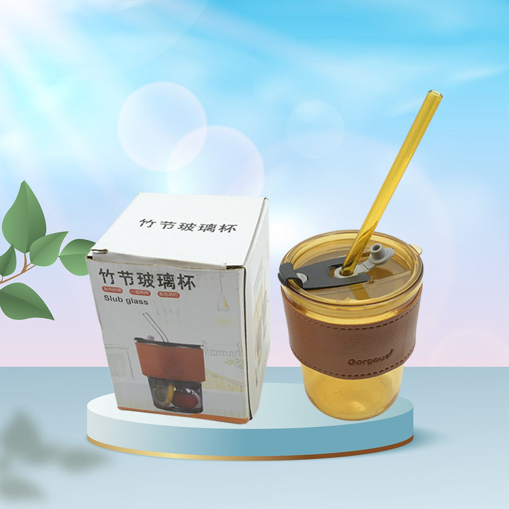 Stylish transparent glass coffee mug with a matching glass straw and lid.
