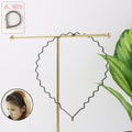 Set of six metal zigzag hair bands with black wavy design