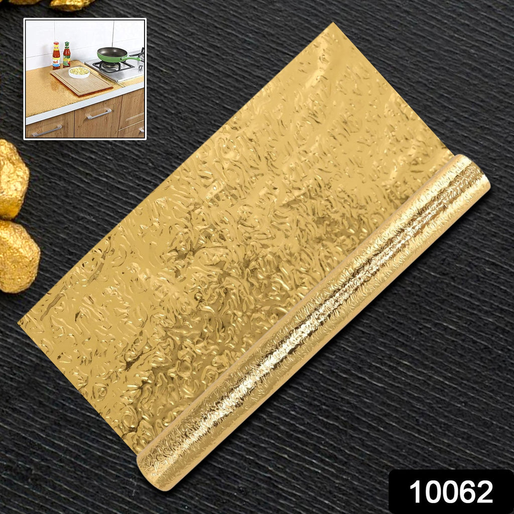 Applying the waterproof aluminum foil sticker to a kitchen surface.