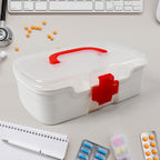 The white First Aid Box open, revealing three organised compartments and a detachable tray.
