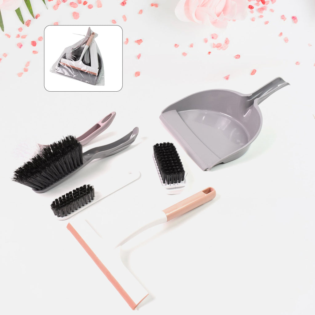 Close-up of the mini broom and dustpan for efficient desk cleaning.