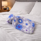 Floral printed hot water bag with soft plush cover showing floral design