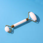 Dual-ended face massage roller with cooling stone heads on a clean background.