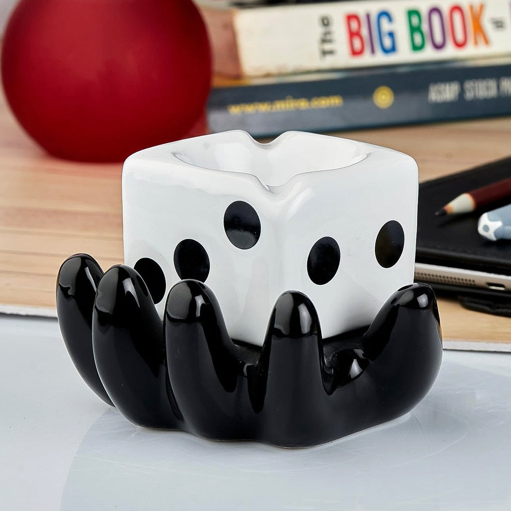 Modern ceramic ashtray with funky patterns and cigarette grooves