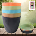 Set of five round plastic flower pots with trays displayed on a natural wooden surface.