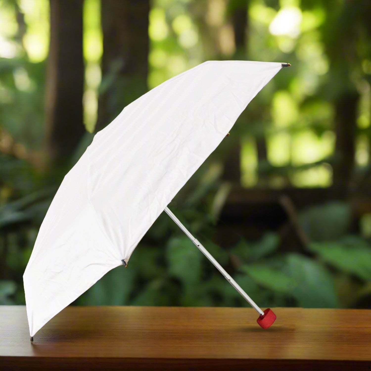 View of the DrizzlePro foldable umbrella, showcasing its remarkably compact size when closed.