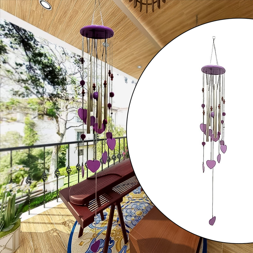 Smiley hearts wind chime with bamboo and aluminium tubes hanging outdoors.